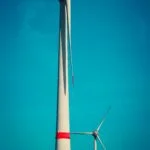 a large windmill with a blue sky
